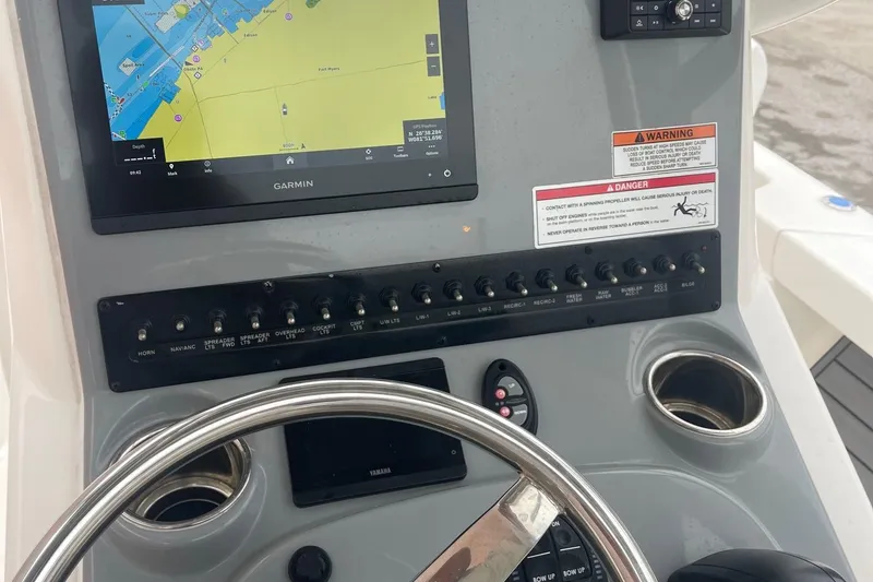 Slide: The Image of 2024 Pathfinder 2200 TRS boat dashboard with Garmin navigation system and control panel. - 15