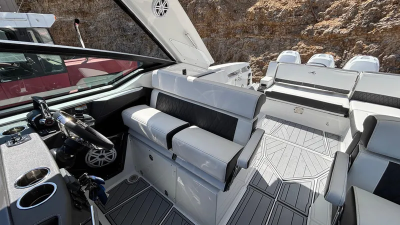 Slide: The Image of 2023 Monterey 385SS boat interior with sleek seating and modern dashboard design. - 10