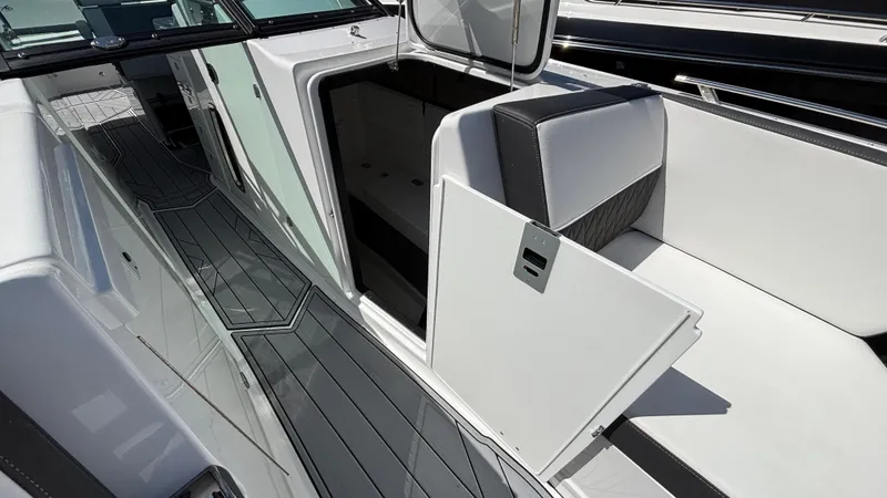 Slide: The Image of 2023 Monterey 385SS boat interior with open storage compartment and sleek seating. - 18