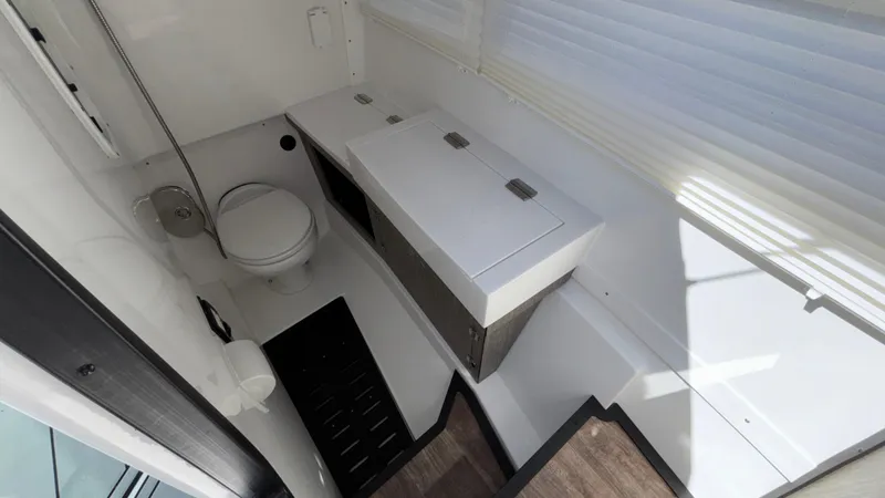 Slide: The Image of 2023 Monterey 385SS boat bathroom with toilet, sink, and storage cabinet. - 21