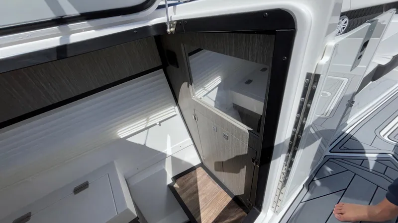Slide: The Image of 2023 Monterey 385SS boat interior with open cabin door and sleek design. - 22