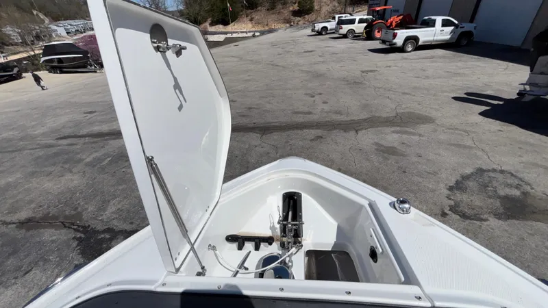 Slide: The Image of 2023 Monterey 385SS boat with open storage compartment, parked outdoors. - 23