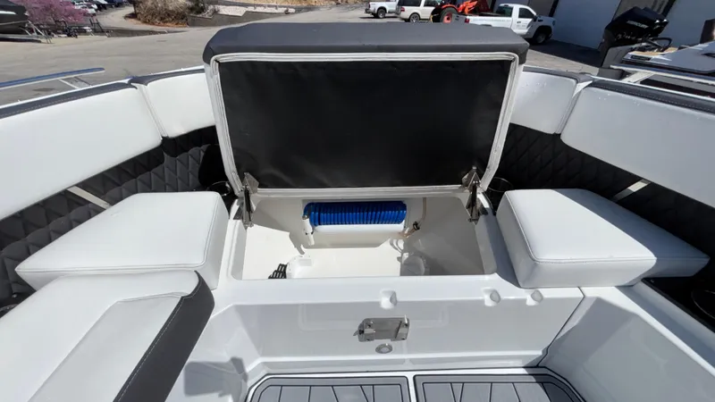 Slide: The Image of 2023 Monterey 385SS boat interior with open storage compartment and cushioned seating. - 24