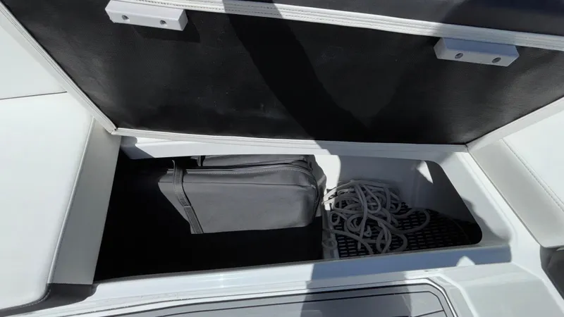 Slide: The Image of Storage compartment in 2023 Monterey 385SS boat with bag and rope. - 27