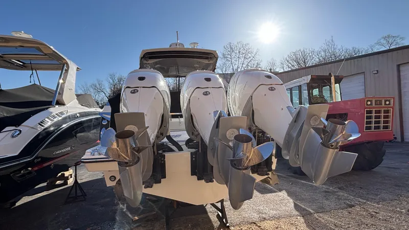 Slide: The Image of 2023 Monterey 385SS boat with powerful outboard engines in a sunny outdoor setting. - 3