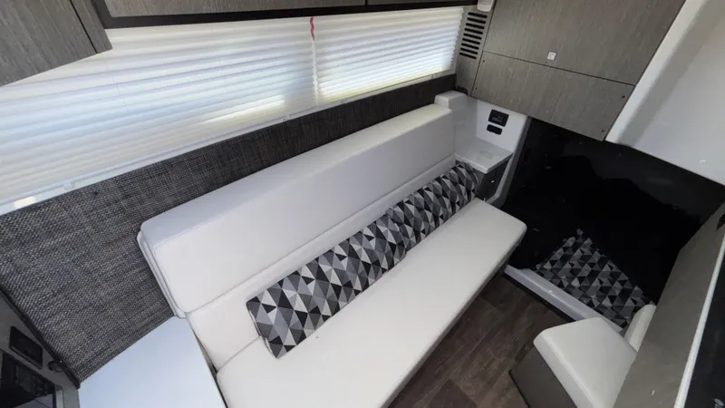 Slide: The Image of 2023 Monterey 385SS interior with modern seating and geometric-patterned cushions. - 32