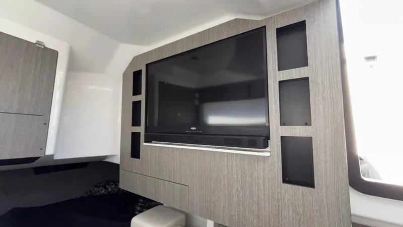 Slide: The Image of 2023 Monterey 385SS interior with modern entertainment system and sleek cabinetry. - 33