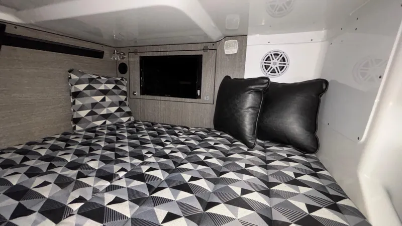 Slide: The Image of 2023 Monterey 385SS cabin interior with geometric bedding and pillows. - 39