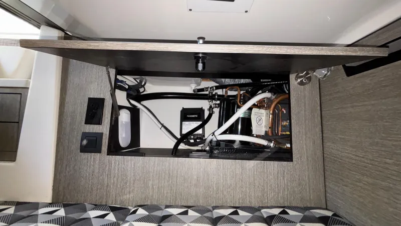 Slide: The Image of 2023 Monterey 385SS interior compartment with visible wiring and components. - 40