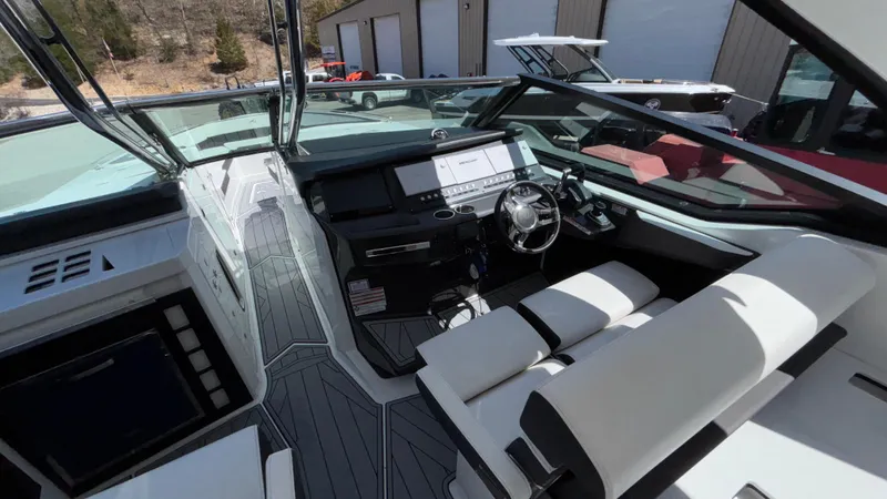 Slide: The Image of 2023 Monterey 385SS boat interior with modern dashboard and luxurious seating. - 45