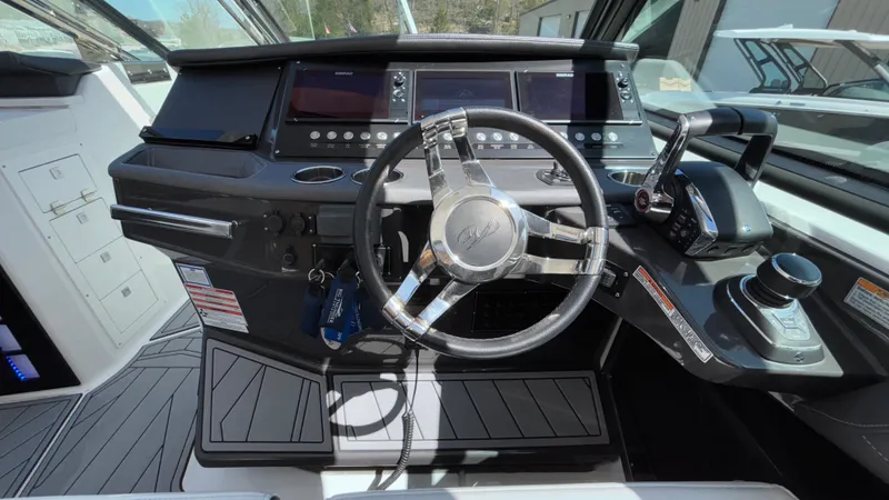 Slide: The Image of 2023 Monterey 385SS boat cockpit with modern steering wheel and control panel. - 46