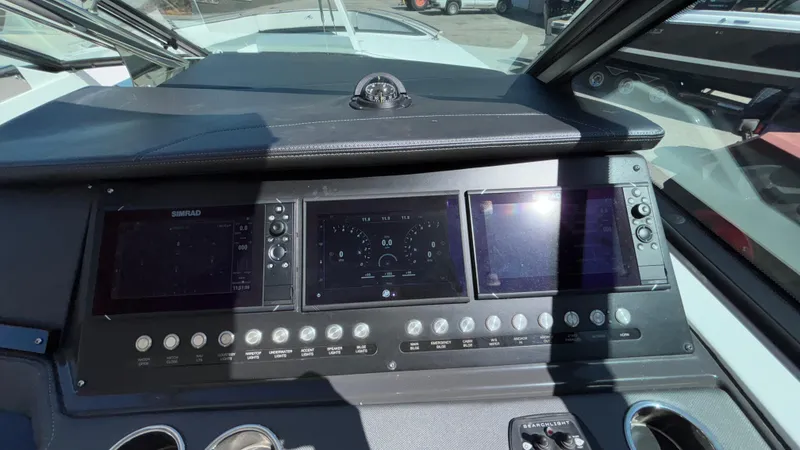 Slide: The Image of 2023 Monterey 385SS boat dashboard with advanced navigation displays and controls. - 47