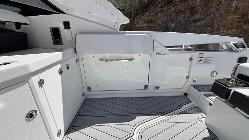 Slide: The Image of 2023 Monterey 385SS boat interior with sleek white cabinetry and modern design. - 9