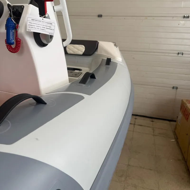 Slide: The Image of 2025 Highfield Sport 330 inflatable boat in a garage setting. - 12