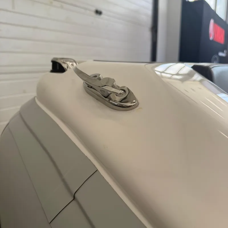 Slide: The Image of 2025 Highfield Sport 330 inflatable boat displayed indoors with seating and control console. - 3