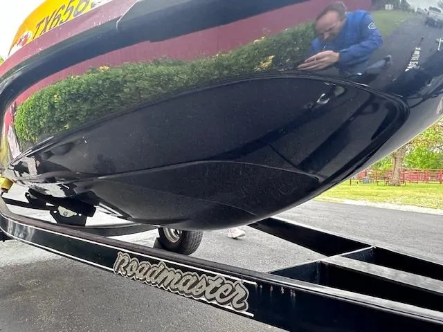 Slide: The Image of 2011 Sea-Doo RXT 260 on Roadmaster trailer, reflective surface, outdoor setting. - 11