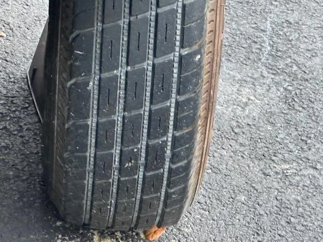 Slide: The Image of Close-up of a worn tire on asphalt, related to a 2011 Sea-Doo RXT 260. - 15