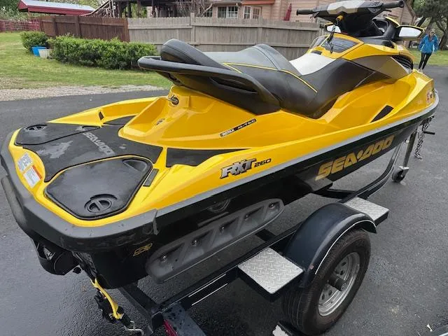 Slide: The Image of 2011 Sea-Doo RXT 260 jet ski in yellow and black on a trailer. - 4