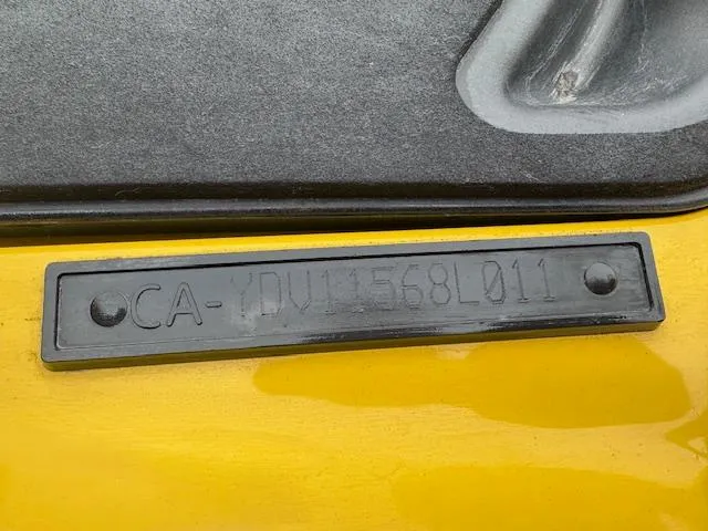 Slide: The Image of Close-up of a 2011 Sea-Doo RXT 260 identification plate on a yellow surface. - 7