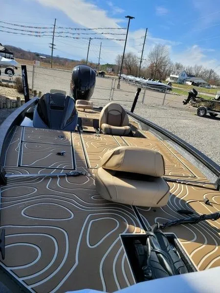 Slide: The Image of 2023 Xpress X21 Pro boat with stylish seating and modern design in a sunny outdoor setting. - 3