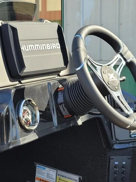 Slide: The Image of 2023 Xpress X21 Pro boat dashboard with Humminbird display and steering wheel. - 7