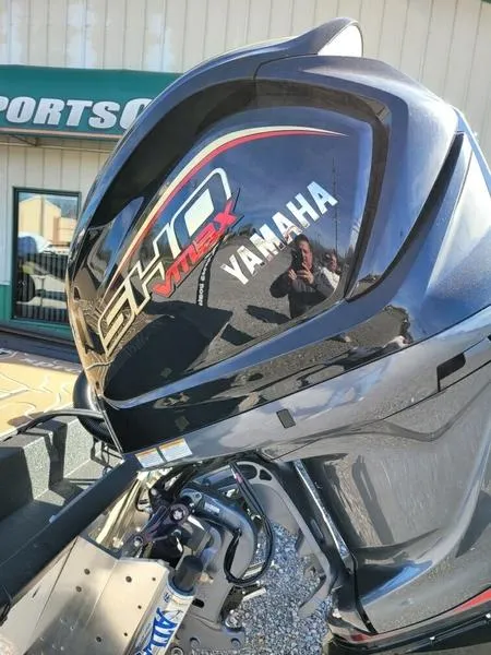 Slide: The Image of Yamaha SHO VMAX engine on 2023 Xpress X21 Pro boat, outdoors at a dealership. - 9