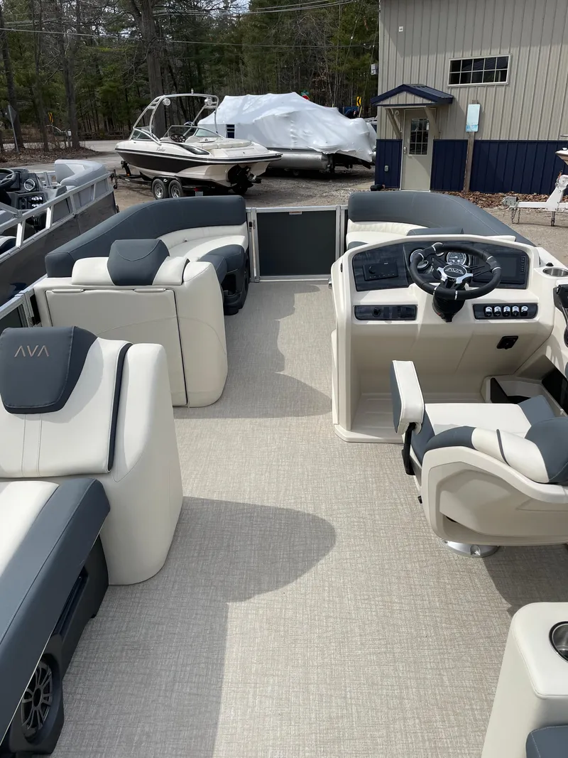 Slide: The Image of 2025 Avalon 23 LSZ Elite pontoon boat interior with modern seating and steering console. - 6