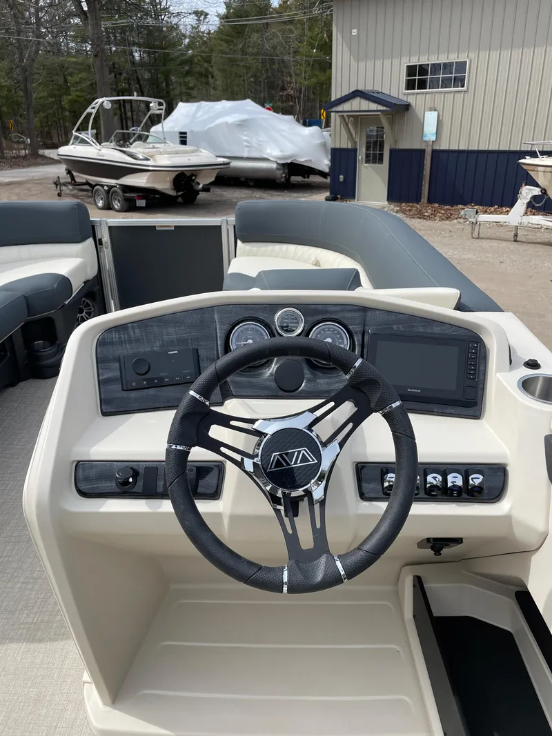 Slide: The Image of 2025 Avalon 23 LSZ Elite boat dashboard with modern steering and controls. - 7