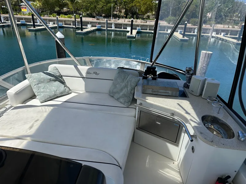 Slide: The Image of Luxurious 2008 Sea Ray 47 Sedan Bridge yacht interior with plush seating and scenic marina view. - 21