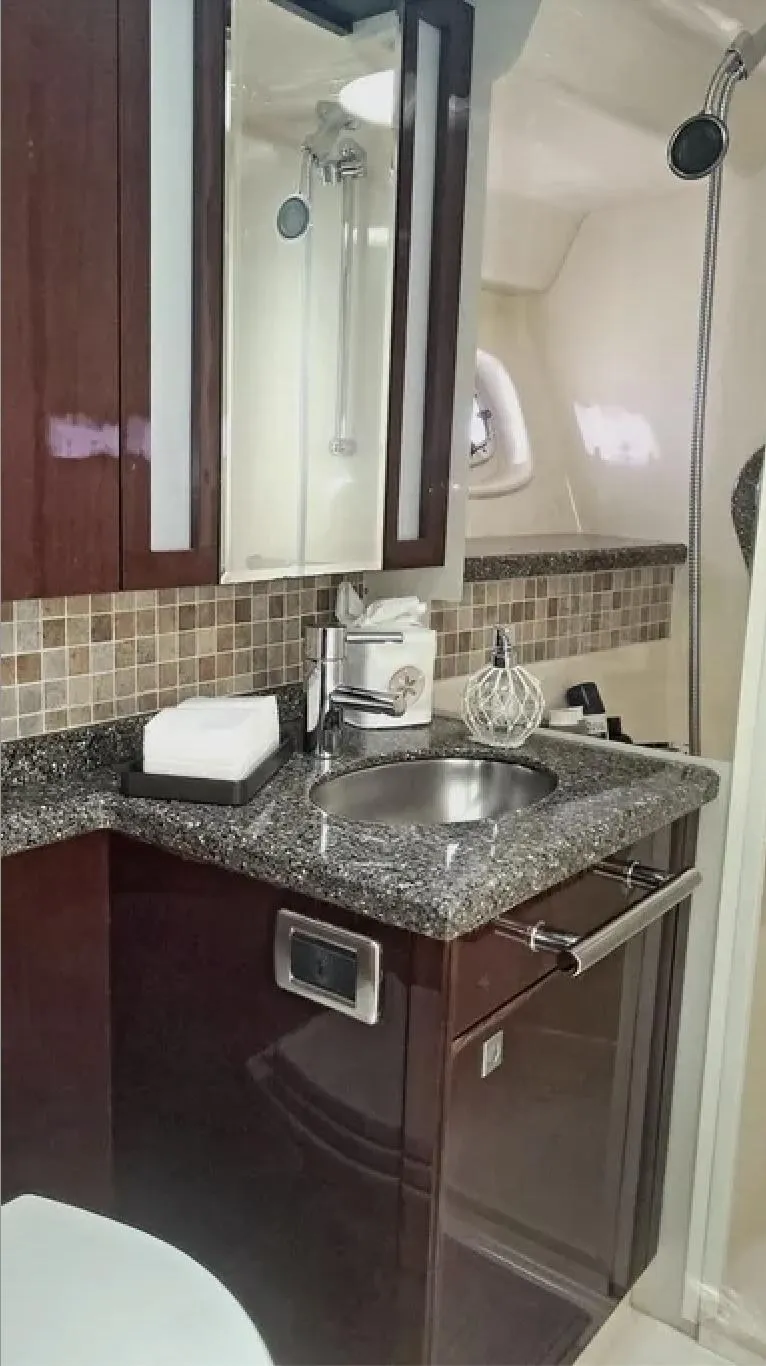 Slide: The Image of Luxurious bathroom in 2008 Sea Ray 47 Sedan Bridge yacht with modern fixtures and granite countertop. - 30