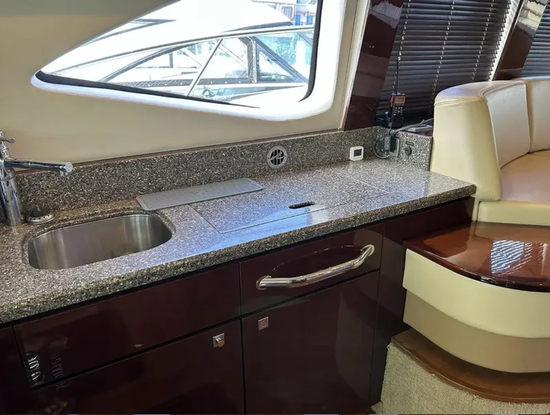 Slide: The Image of Luxurious 2008 Sea Ray 47 Sedan Bridge yacht interior with sleek kitchen countertop and seating. - 32