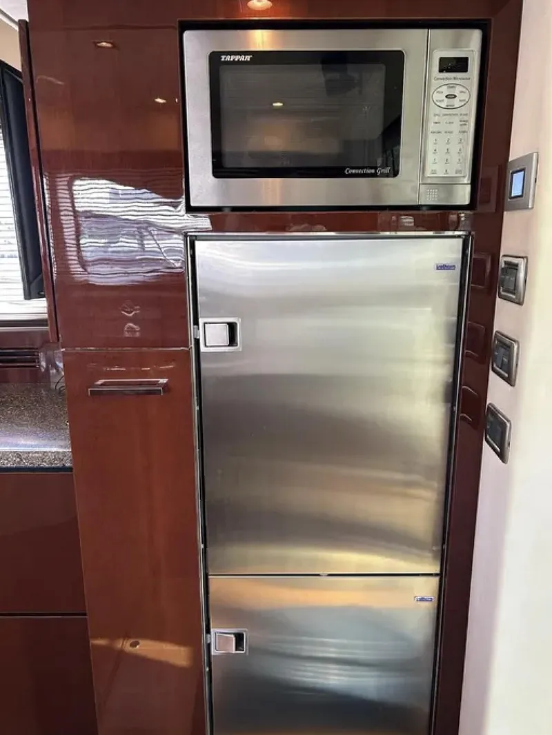 Slide: The Image of Microwave and stainless steel fridge in 2008 Sea Ray 47 Sedan Bridge yacht kitchen. - 33