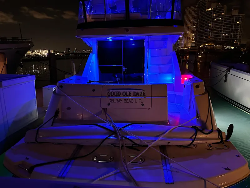 Slide: The Image of 2008 Sea Ray 47 Sedan Bridge yacht docked at night with blue lighting. - 38