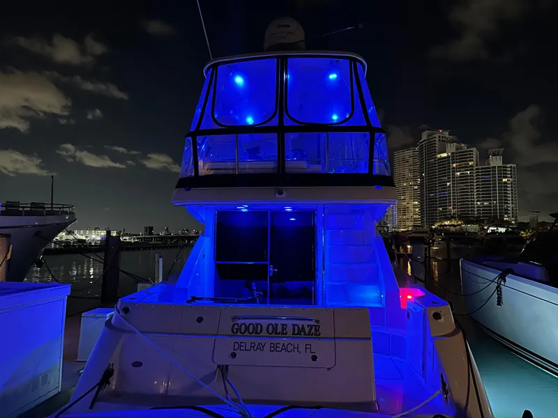 Slide: The Image of 2008 Sea Ray 47 Sedan Bridge yacht illuminated with blue lights at night, docked in Delray Beach. - 39