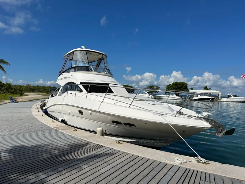 Slide: The Image of 2008 Sea Ray 47 Sedan Bridge yacht docked under clear blue sky. - 42