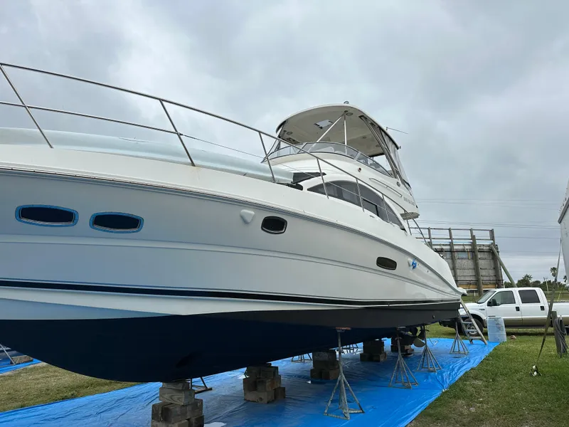 Slide: The Image of 2008 Sea Ray 47 Sedan Bridge yacht on stands, side view, overcast sky. - 6