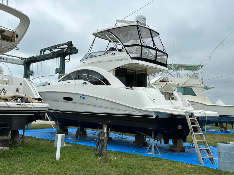 Slide: The Image of 2008 Sea Ray 47 Sedan Bridge yacht on dry dock, surrounded by other boats. - 7