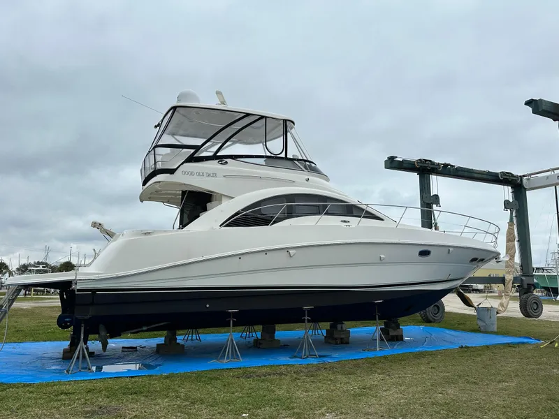 Slide: The Image of 2008 Sea Ray 47 Sedan Bridge yacht on stands, displayed outdoors under cloudy skies. - 8