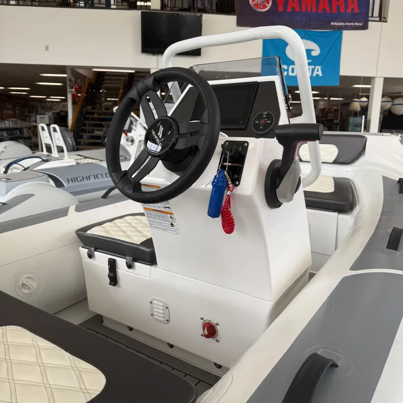 Slide: The Image of 2025 Highfield Sport 360 boat interior with quilted seating in showroom. - 10