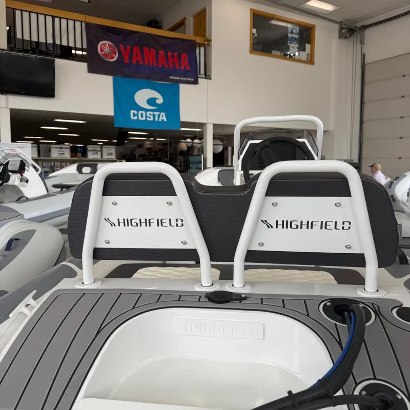 Slide: The Image of 2025 Highfield Sport 360 boat interior with steering wheel and control panel. - 11