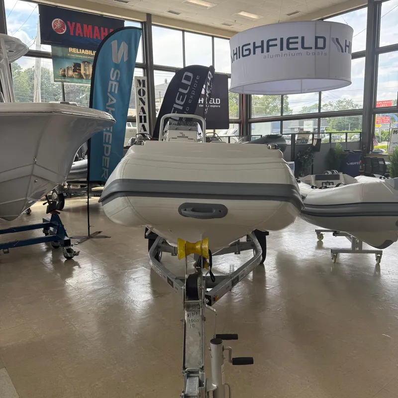 Slide: The Image of 2025 Highfield Sport 360 boat displayed indoors on a trailer. - 3