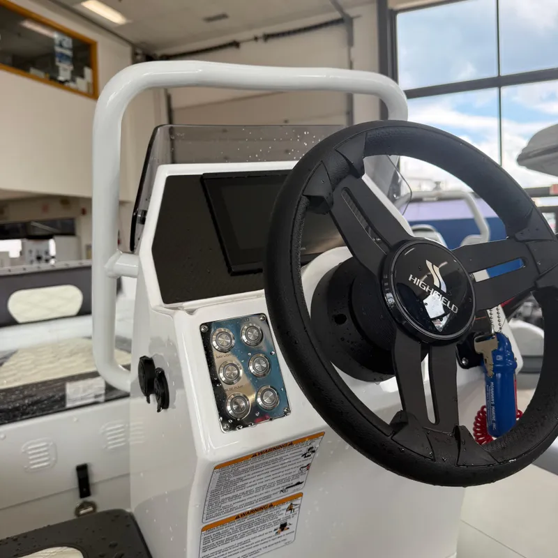 Slide: The Image of 2025 Highfield Sport 360 boat displayed indoors on a trailer. - 5