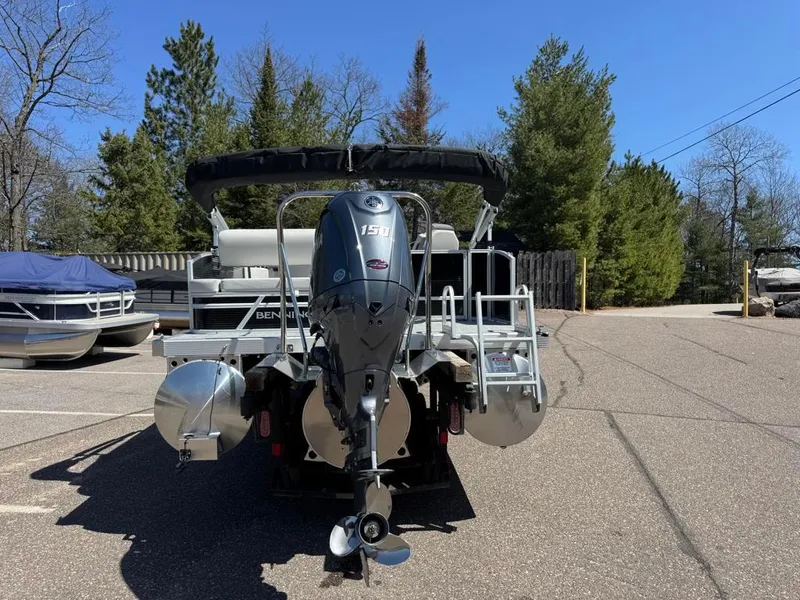 Slide: The Image of 2025 Bennington 22SSB-SPS pontoon boat with Yamaha 150 engine, parked outdoors. - 10
