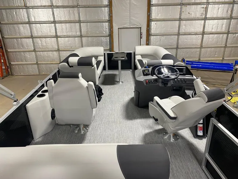 Slide: The Image of 2025 Bennington 22SSB-SPS pontoon boat interior with modern seating and steering console. - 11