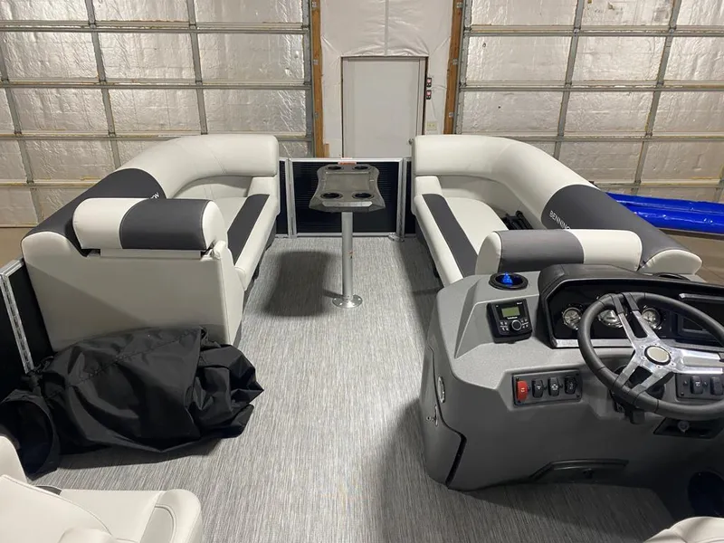 Slide: The Image of 2025 Bennington 22SSB-SPS pontoon boat interior with plush seating and modern helm. - 12