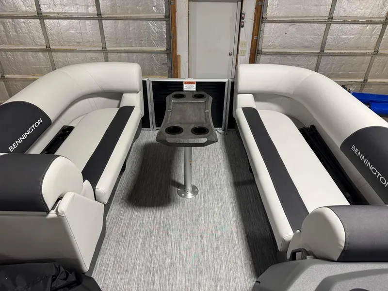 Slide: The Image of 2025 Bennington 22SSB-SPS pontoon boat interior with plush seating and central table. - 13