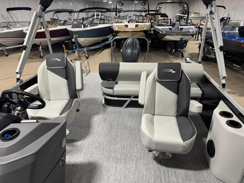 Slide: The Image of 2025 Bennington 22SSB-SPS pontoon boat interior with modern seating and steering console. - 17