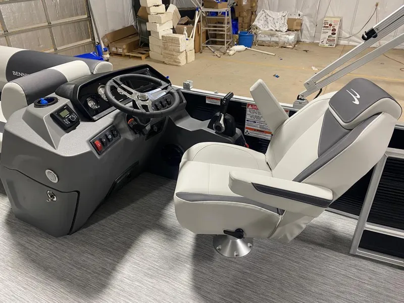 Slide: The Image of 2025 Bennington 22SSB-SPS boat interior with steering console and captain's chair. - 19