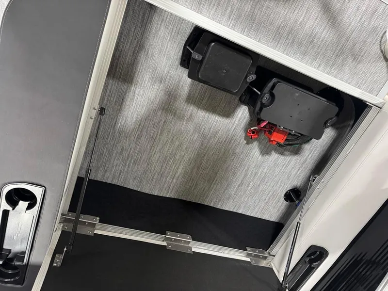 Slide: The Image of Interior view of a 2025 Bennington 22SSB-SPS boat compartment with electrical components. - 23