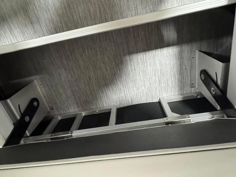 Slide: The Image of Interior view of 2025 Bennington 22SSB-SPS boat, featuring sleek metal and fabric design elements. - 25